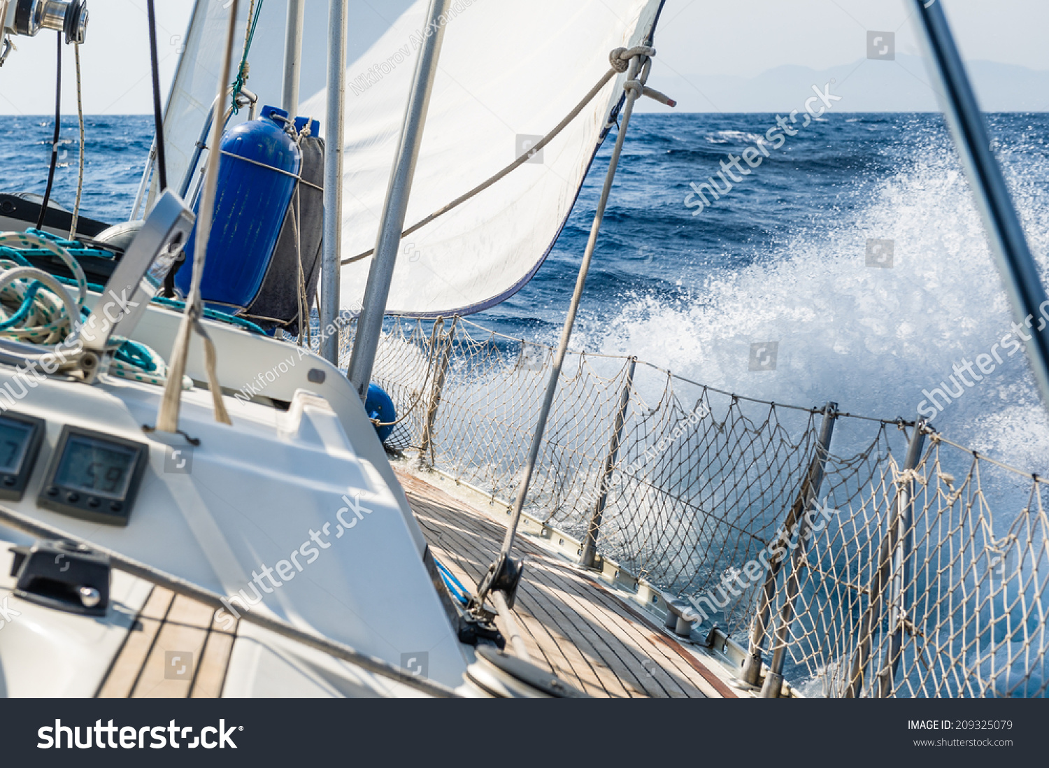 stock-photo-fast-sailing-cruising-yacht-at-heeling-with-splash-209325079